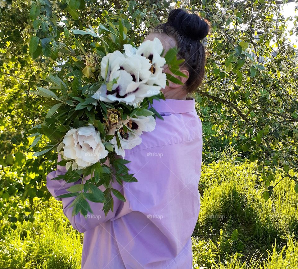Portrait of a girl in a pastel purple shirt with flowers