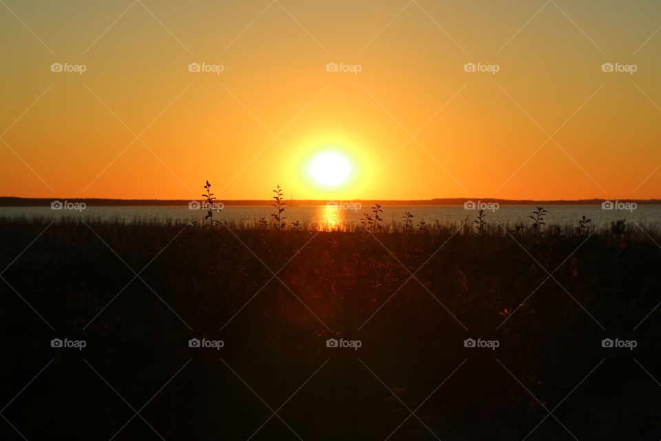 The sun goes down on the beach of Glowe on the island Rügen in Germany