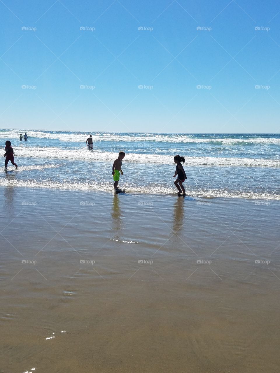kids playing on the shoreline
