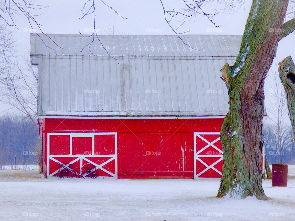Red barn in the snow in winter