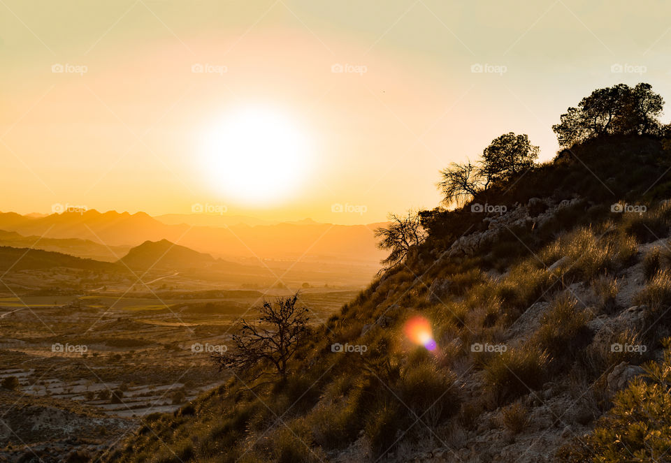 Sunset over foggy countryside landscape in Spain.