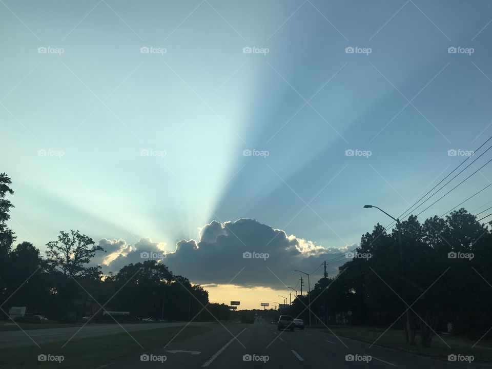 A little taste of heaven while riding down the road near sunset. The cloud with sunlight rays shining above is just amazing!