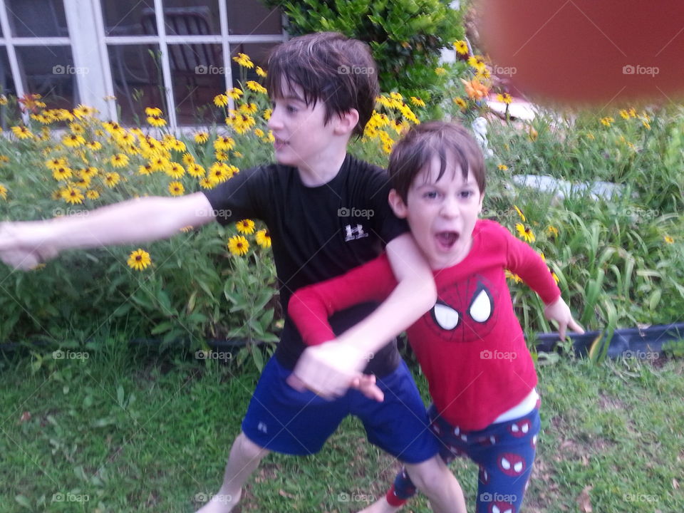 The two brothers playing in Grandmas yard. 