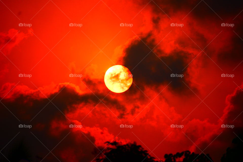 Sunsets by hiding under clouds