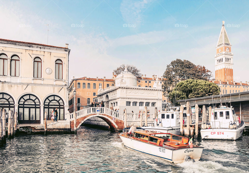 A boat sailing along the canal of Venice