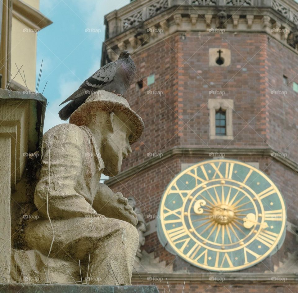 figure of a man with the town hall in the background