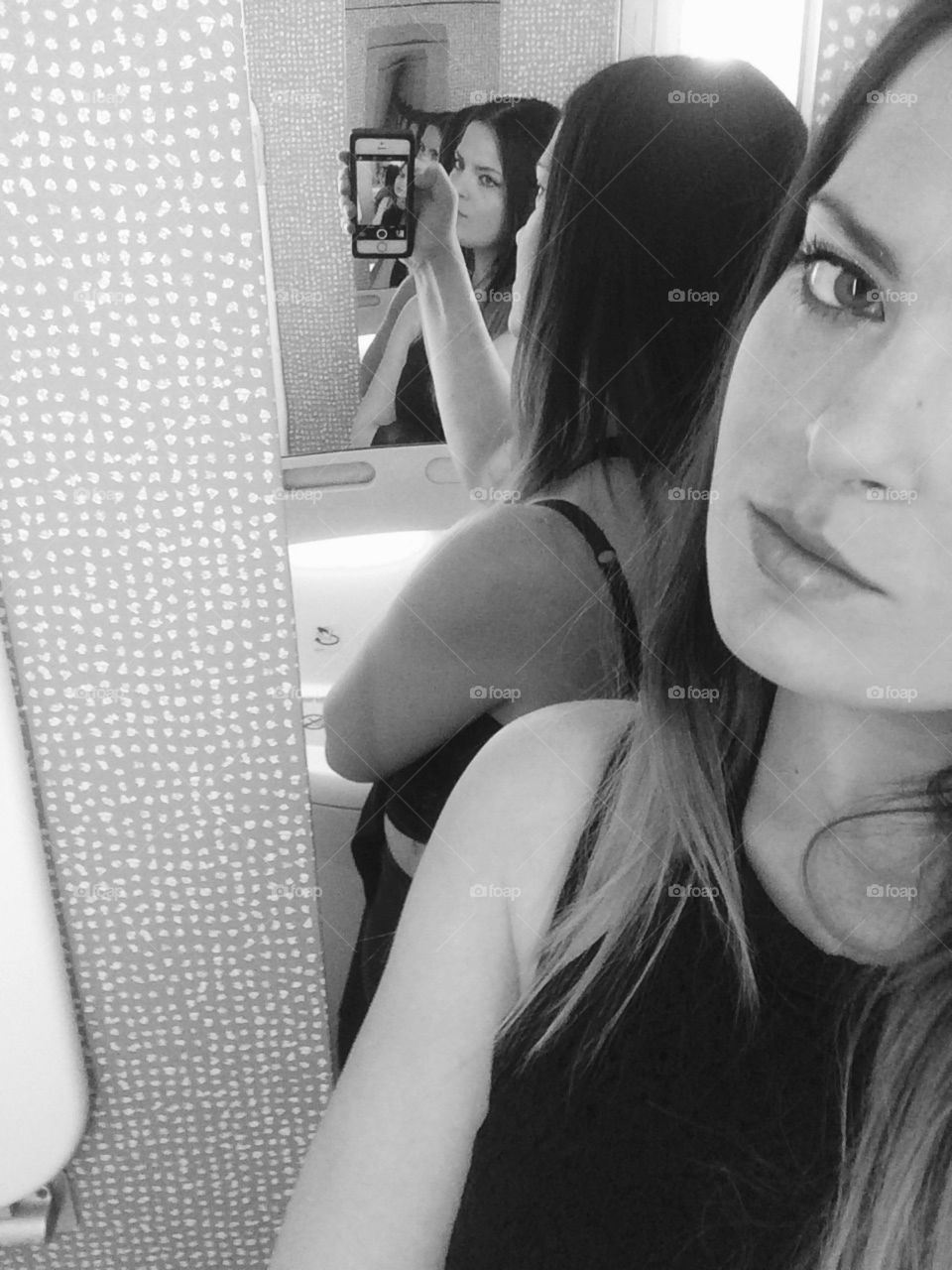 Young attractive girl taking mirror selfie