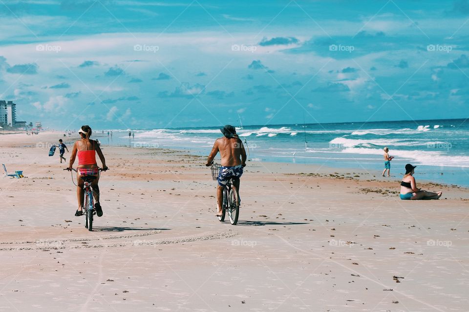 Beach lover cycling in summer 