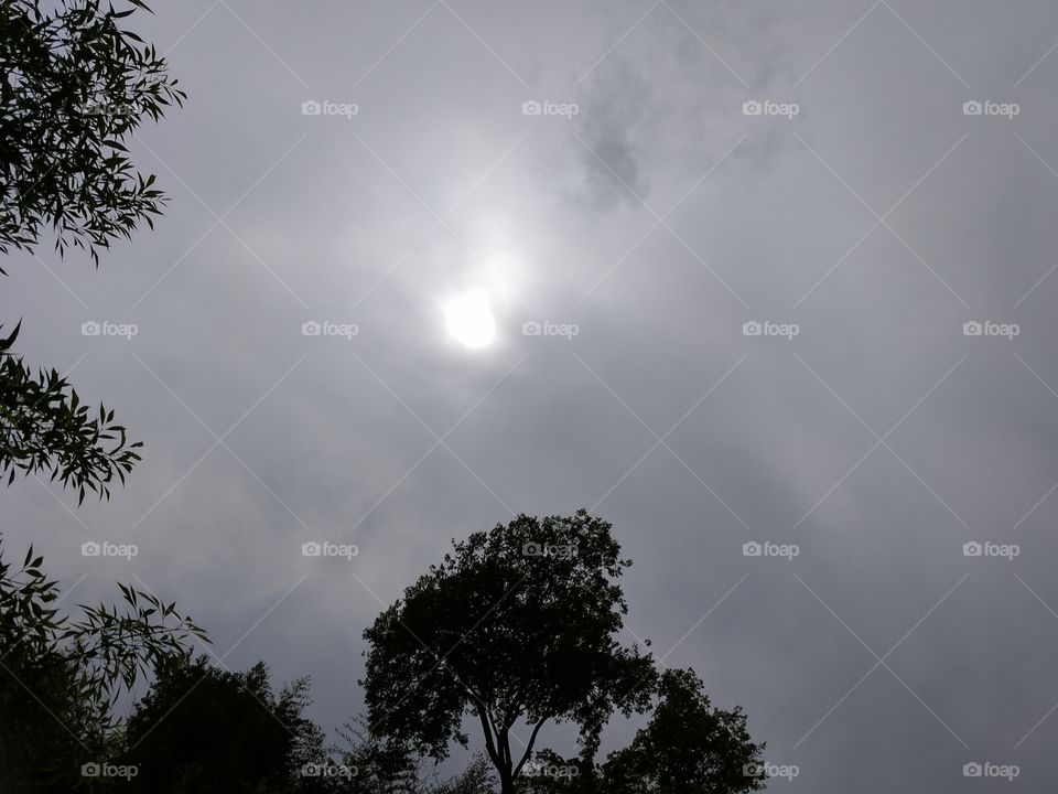 sun fighting the clouds