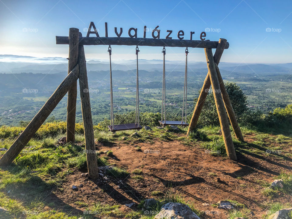 Swings above Alvaiázere, high up looking over the town to the cloud covered mountains in the distance.