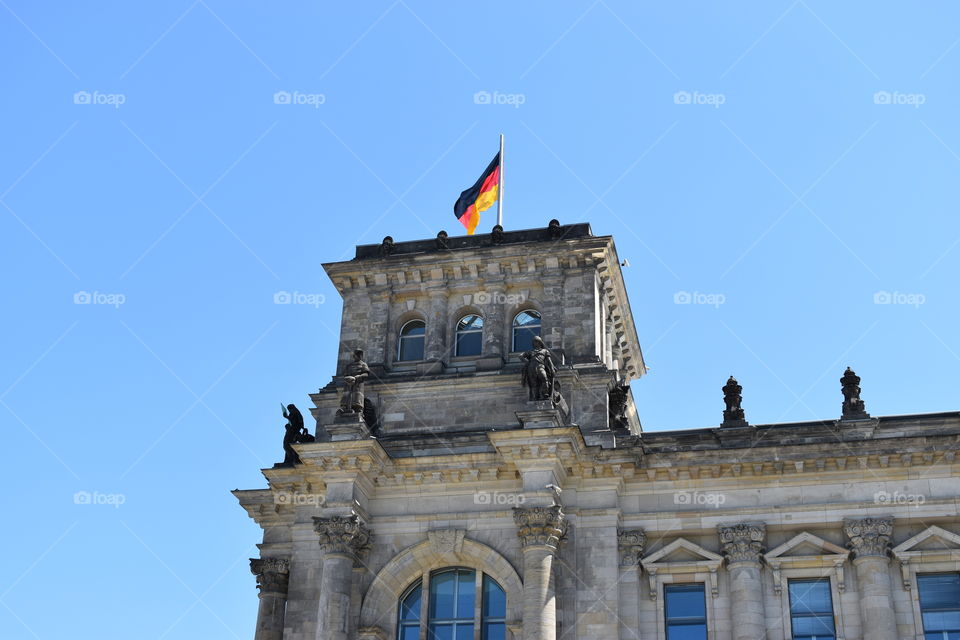 German flag waving in the top of parliament in berlim 