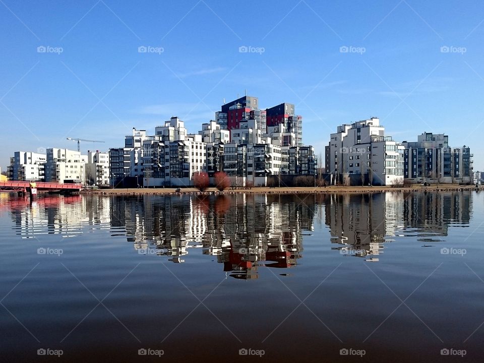 City reflection. Small skyscrapers reflects in the water