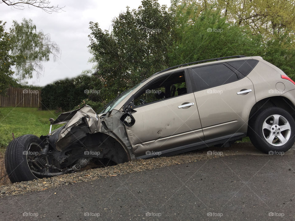 Car in ditch accident on side of road