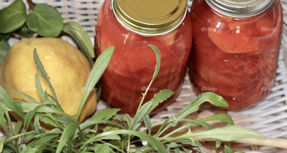 Homemade preserves in two quart jars in wicker basket quince fruit 