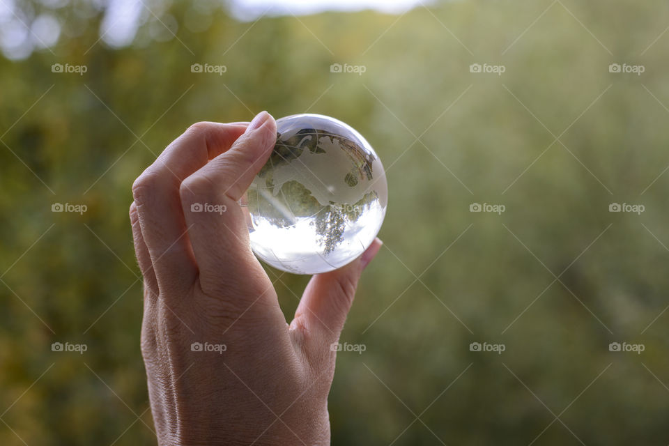 transparent globe in hand