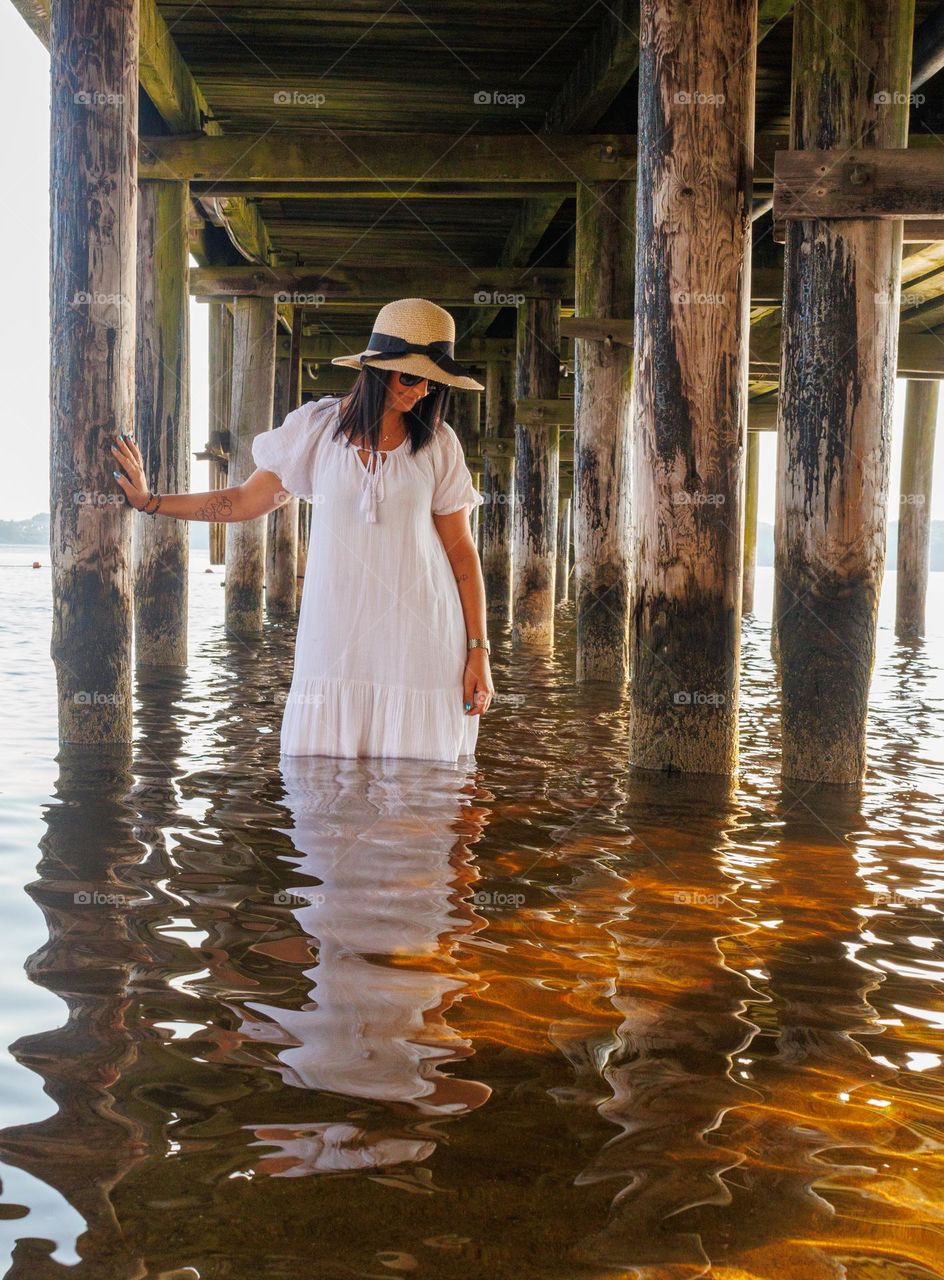 A mysterious woman under the pir ,looking for small fishes. Did she find any,yes she did.