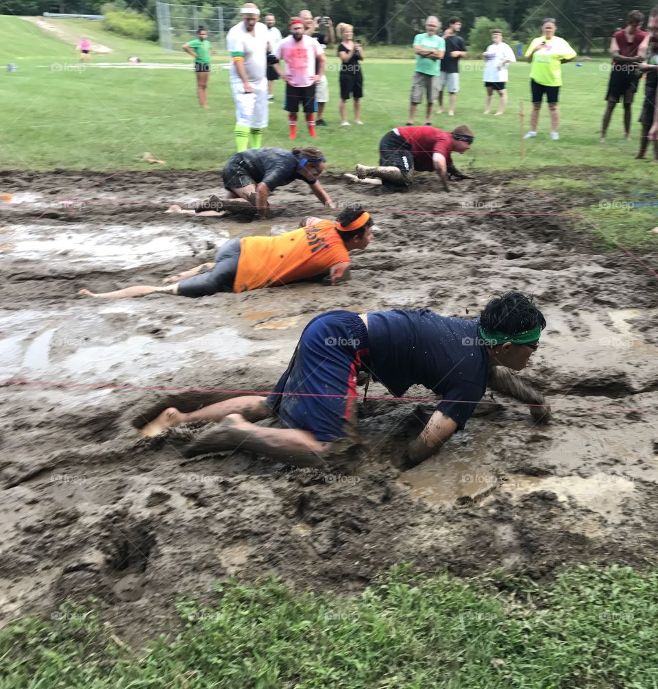 Crazy kids racing through muck in a competition. 