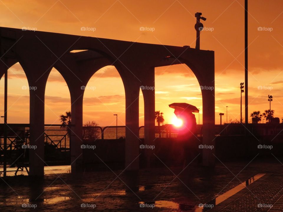 sunset lovers with umbrella. Civitavecchia