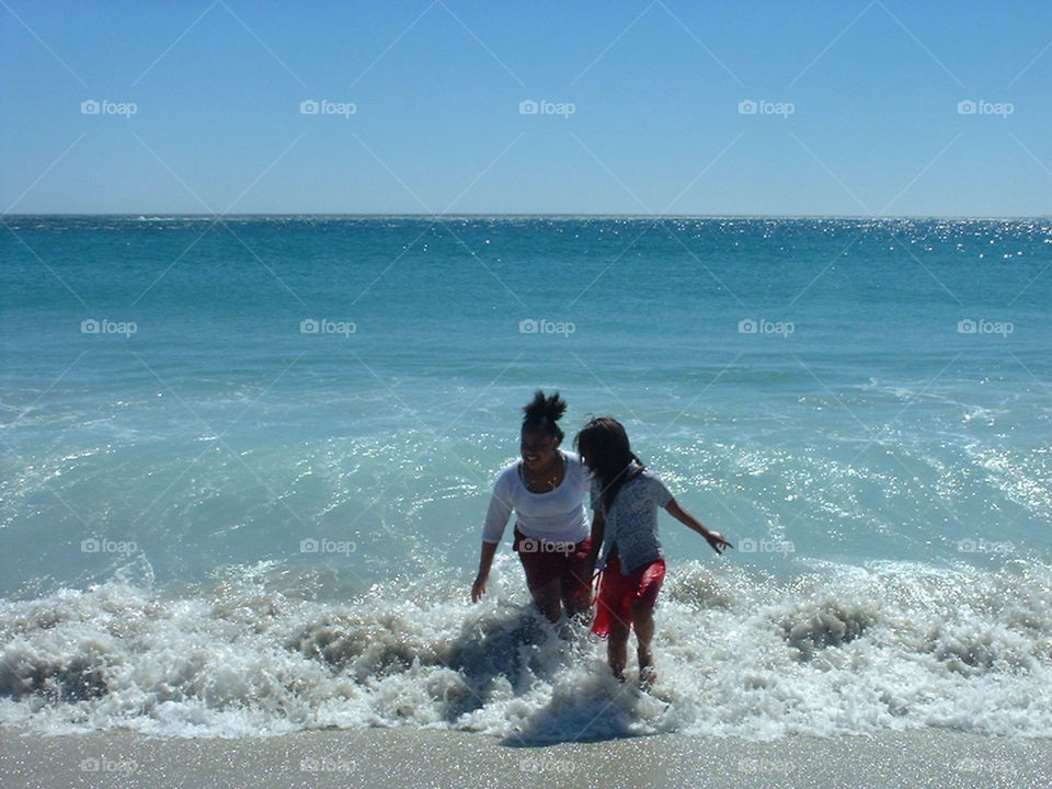 Two girls playing at the beach