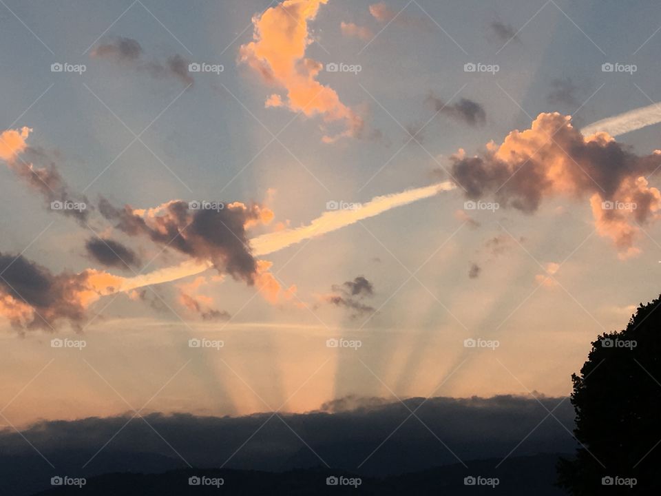 Sunrise in aurora with clouds and the memory of a plane 