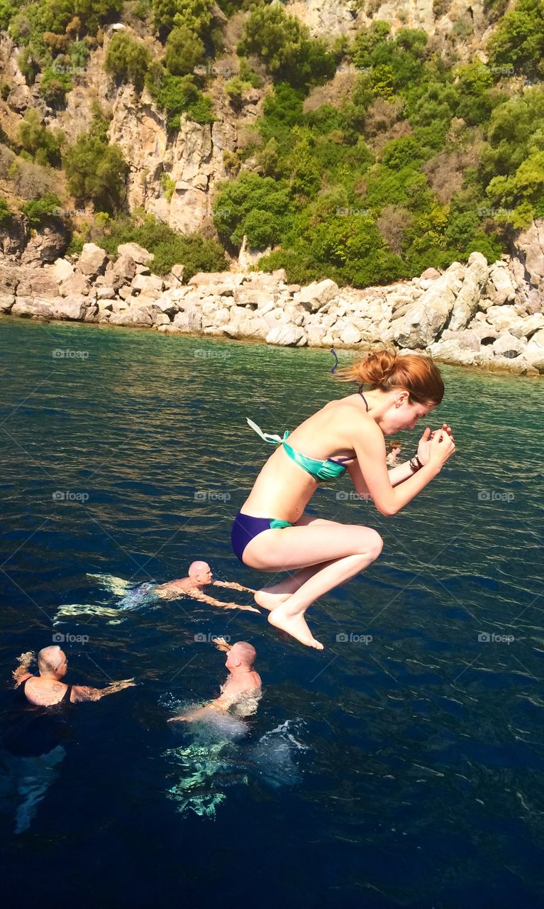 Woman jumping into river