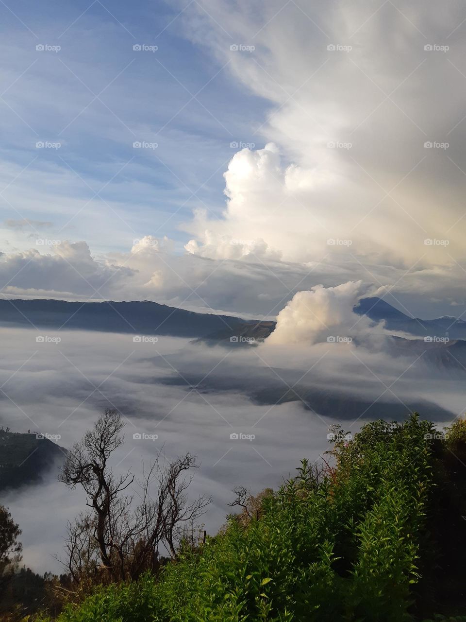 Beautiful white colour of clouds in the mountain. Beautiful nature scenery of the sunrise with bright blue sky