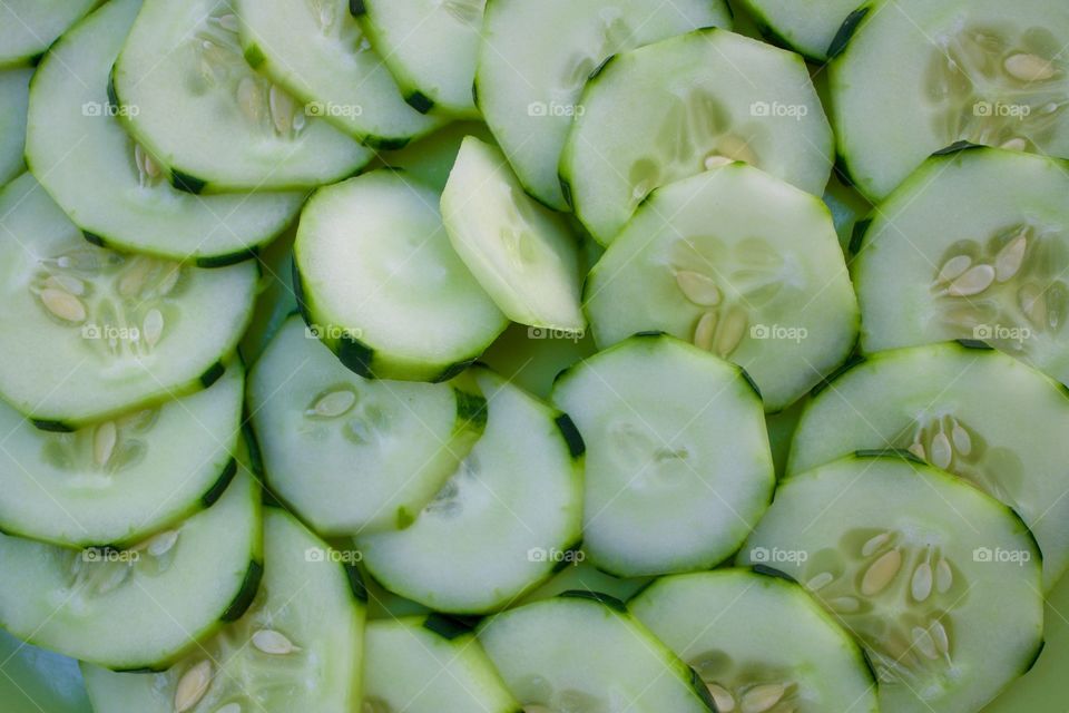 Fruits! - Cucumbers in a spiral pattern on a green plate