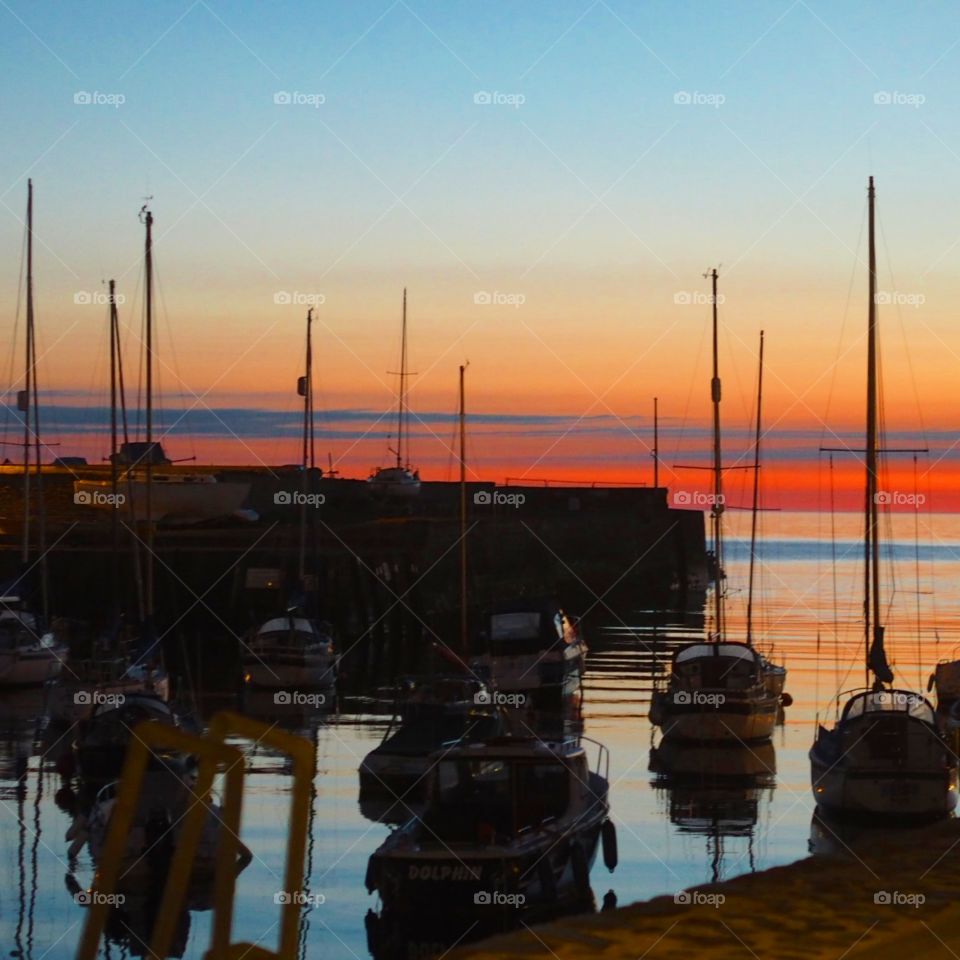 Sunset over Welsh Harbour. Boats in silhouettes  Aberaeron in Ceredigion
