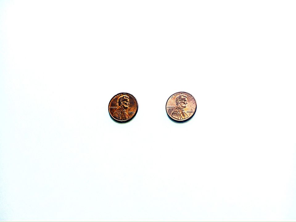Two pennies on a white background 