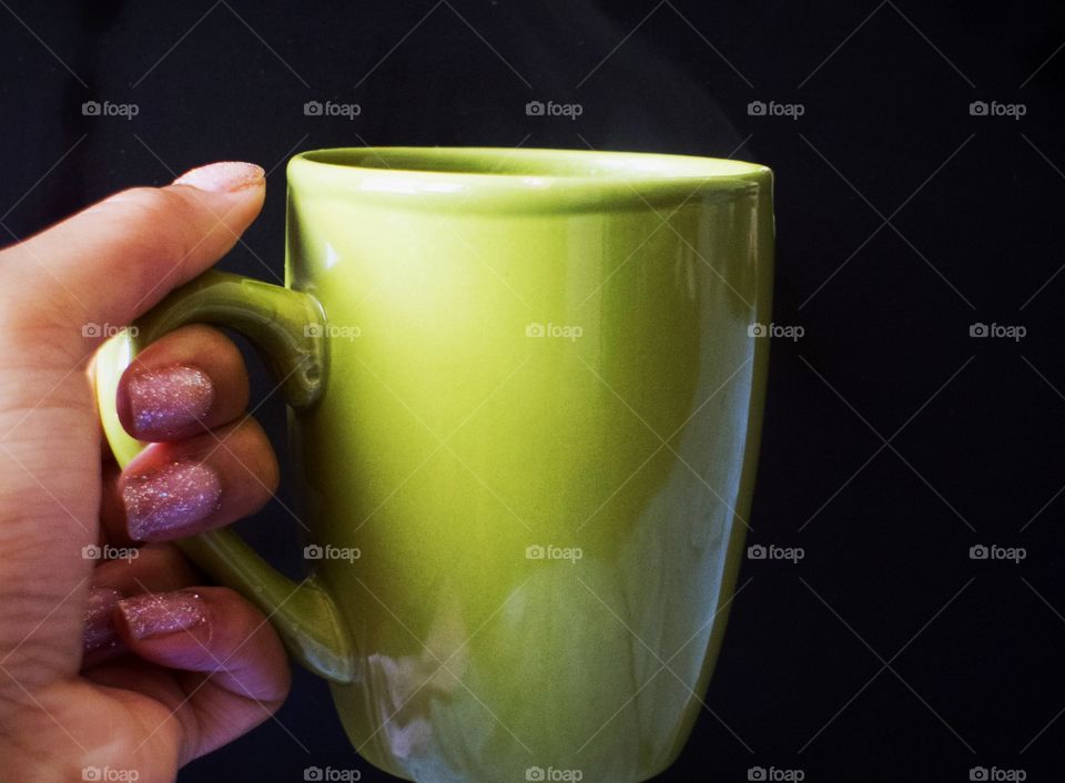 Hand holding a cup of tea 