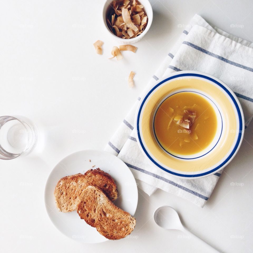 Toasted bread with soup in plate