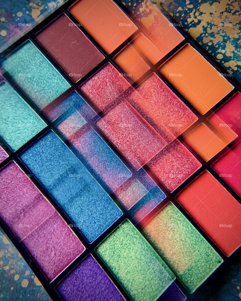 Make up palette in vibrant colours viewed through a kaleidoscope lens attachment 