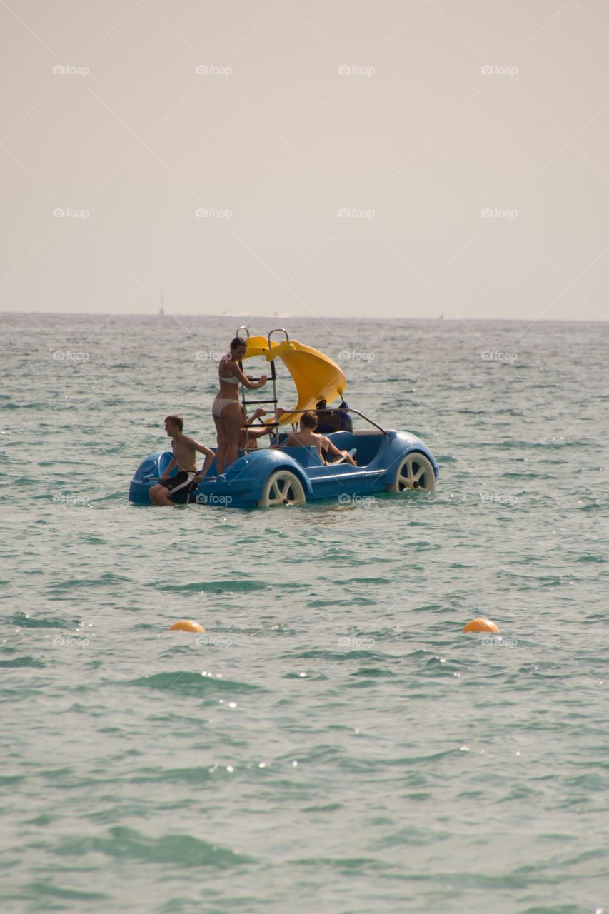 Enjoying in the open ocean in a car boat with slider