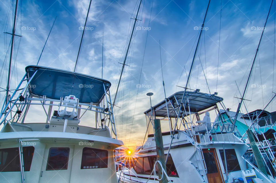 boats at sunset. fishing boats at sunset on cape haterras on outer banks north carolins