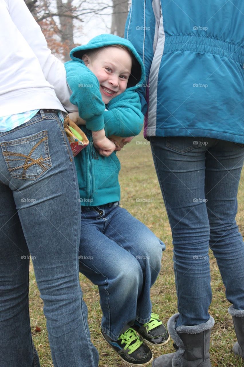 Close-up of two people holding boy