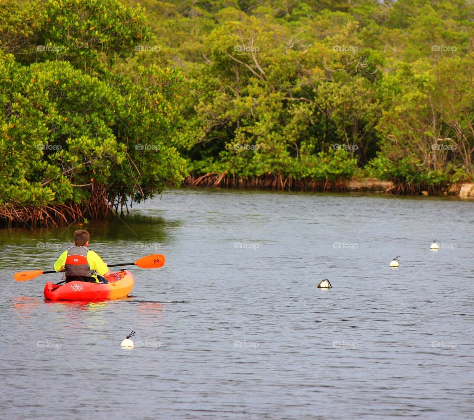 Child kayaking on river