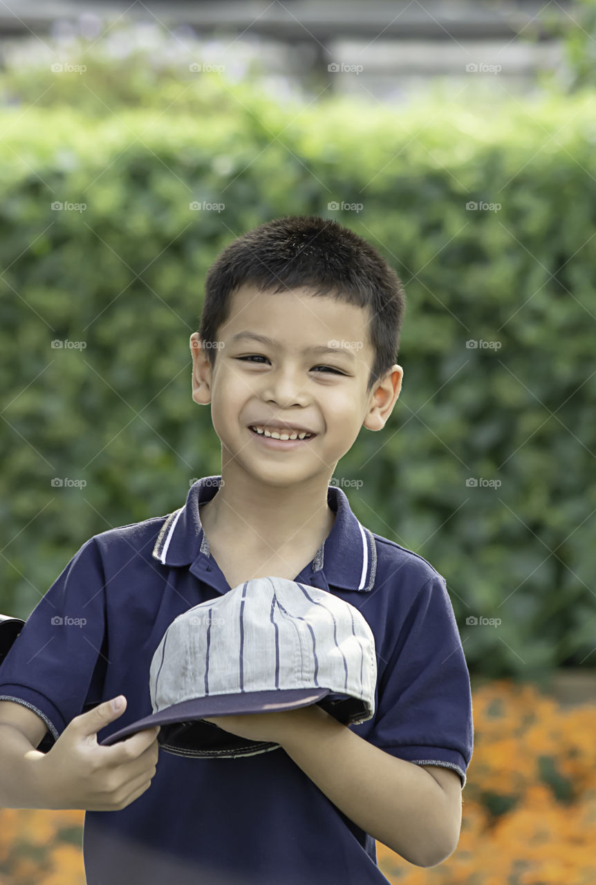 Portrait of Asean boy , laughing and smiling happily in the park.