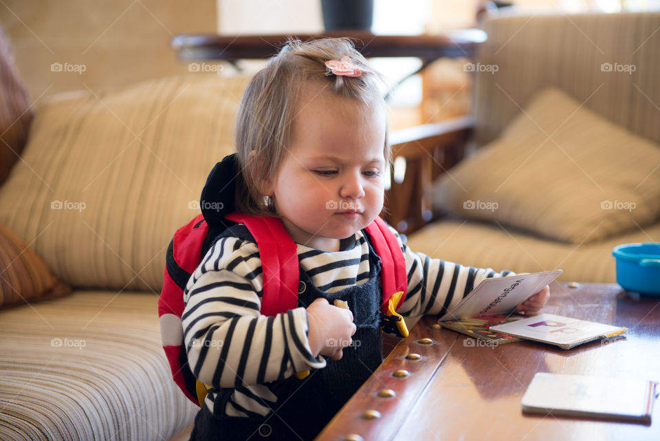 baby girl playing with books