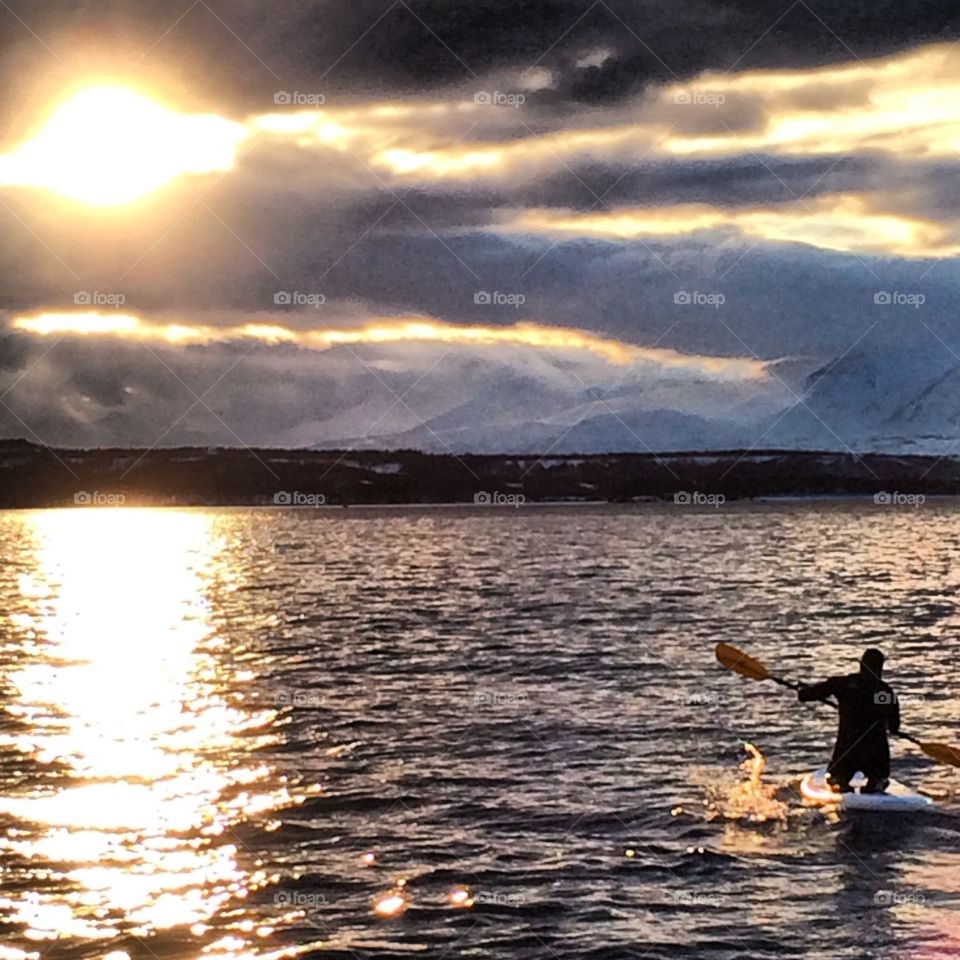 Paddle boarding . Even in February it is possible to use a stand up paddle board in the arctic. This picture is taken in the Lyngen fjord 