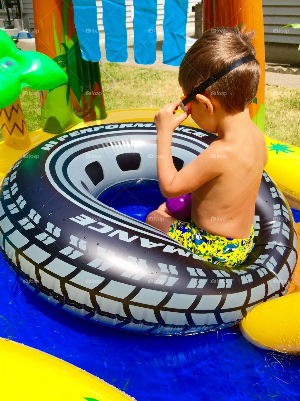 Fun in the Sun. Child playing in his pool