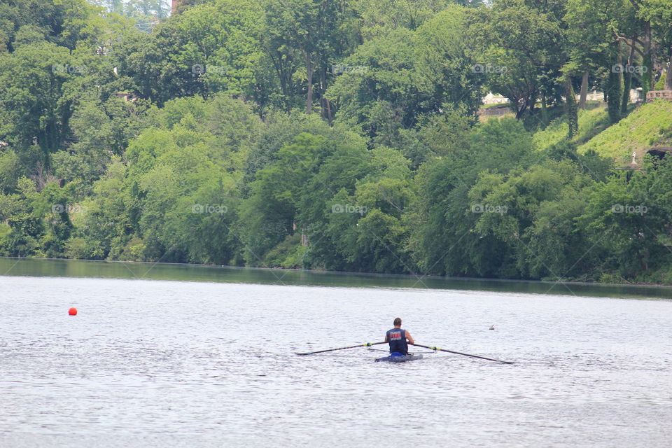 Man in rowboat on the river in Philadelphia