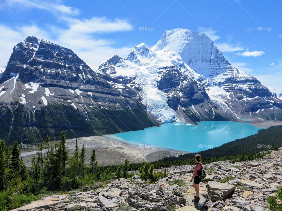 Hiker viewing gorgeous Berg Lake and Mount Robson Glacier in beautiful British Columbia, Canada 
