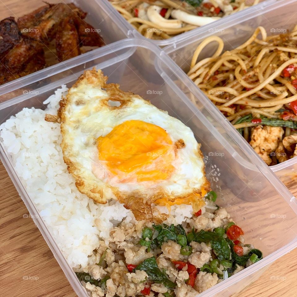 Spicy Thai western fusion meal with noodles , rice and chicken wings 