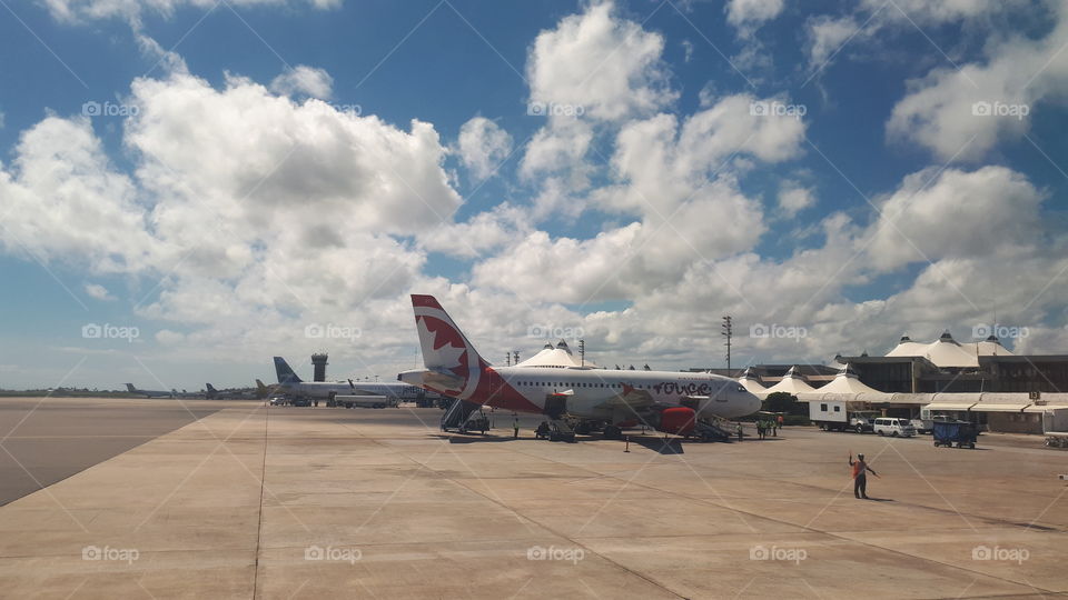On the tarmac in Barbados' Grantley Adam's International Airport, watching an Air Canada plane.