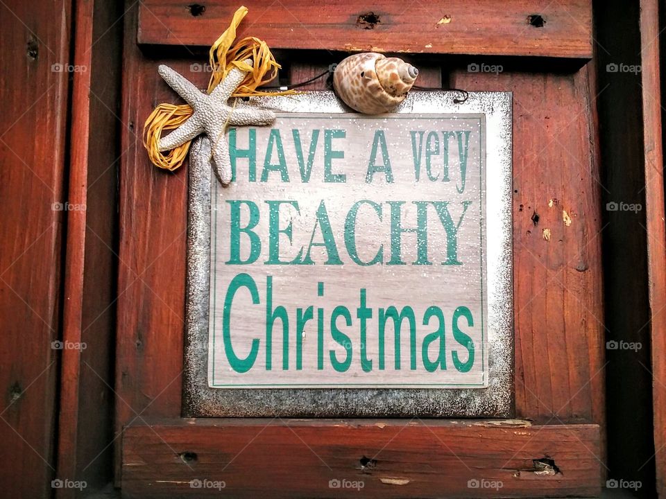 Merry Christmas. Christmas holiday decorative door with a beach theam.