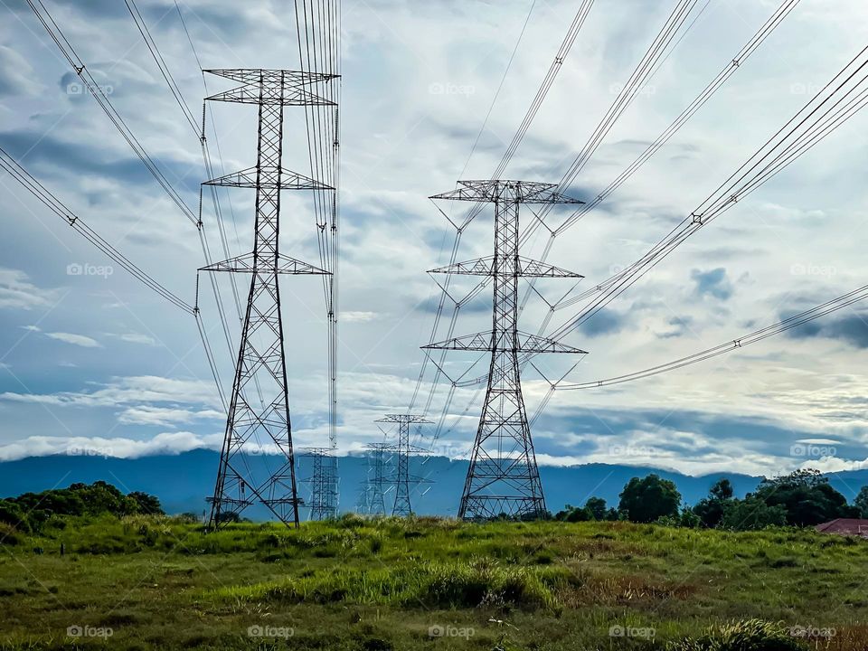 Early morning view of electrical tower and beautiful cloudy sky background 