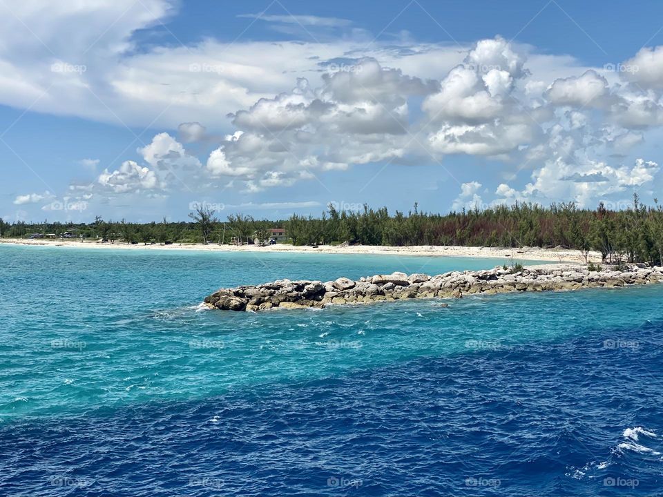 Blue and turquoise water at the entrance to a harbor