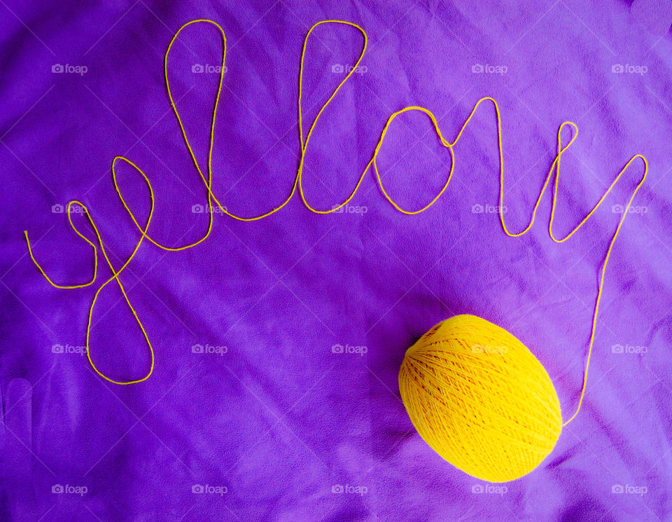 Ball of yellow cotton. Writing yellow 