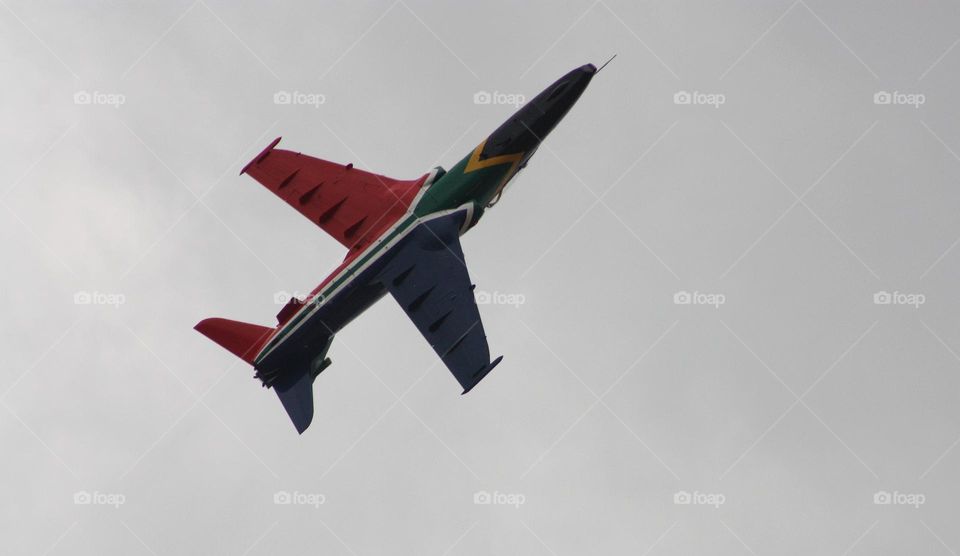 flyby of a fighter plane painted in the colors of the South African flag . freedom day