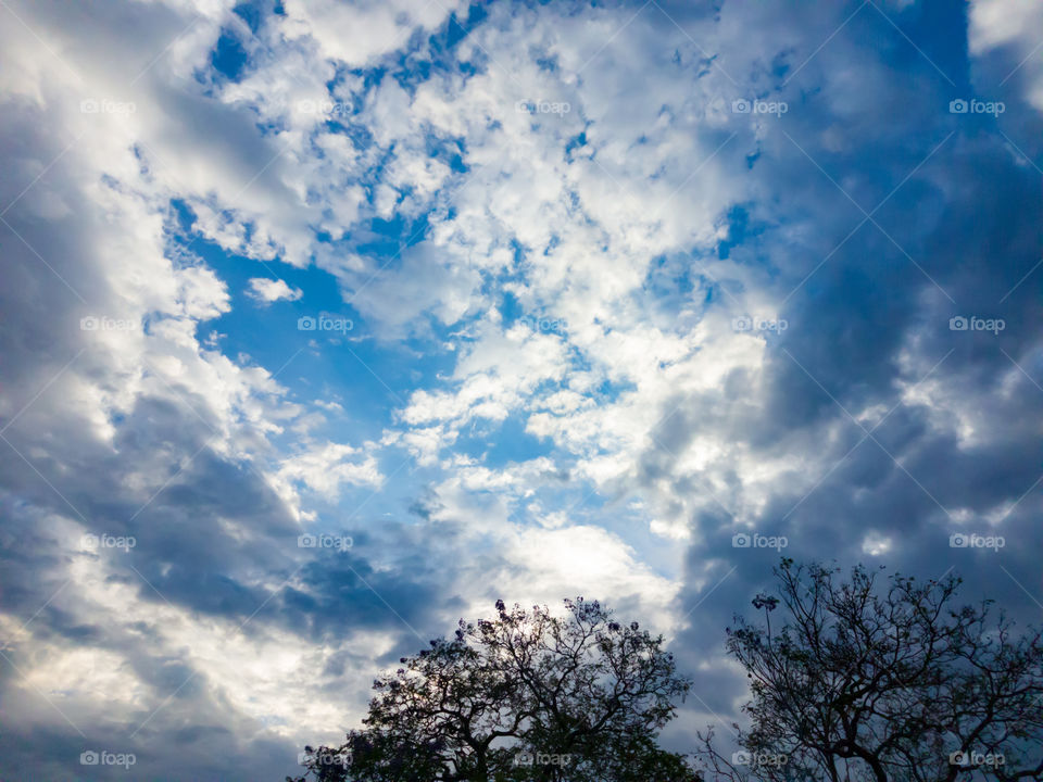 Blue skies inbetween havey rain clouds